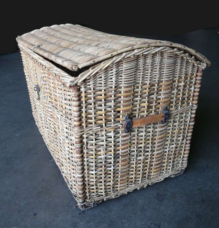 Great old touring era basket of handwoven wicker and wood having leather handles and steel casters on runners. Believed to be for use on the rear carriage of an early model car, but now perfect for use as decorative storage. Lovely patina and size,