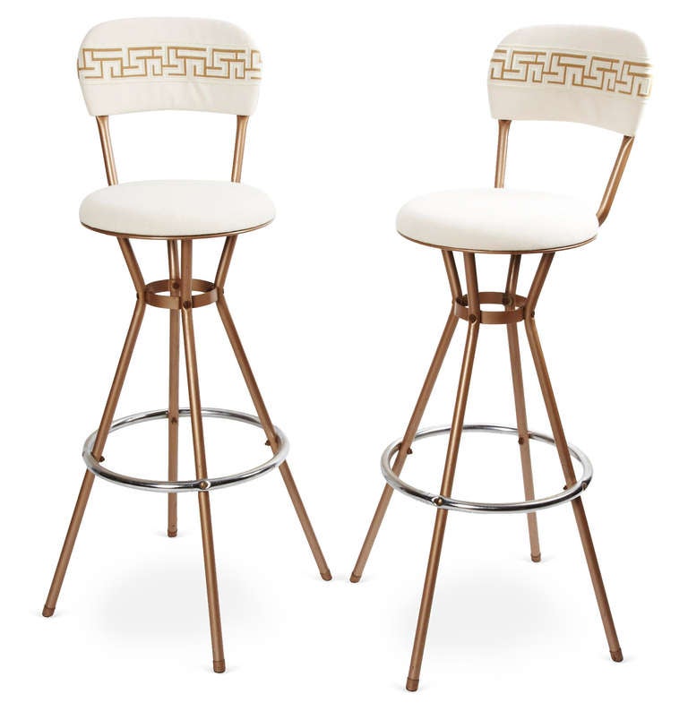 Set of four vintage bar stools with round seat and small curved back. Fabric is a solid light tan with Samuel and Sons tape 2.5