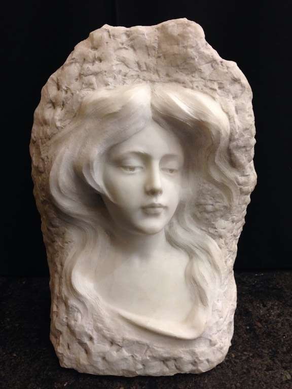 This is a wonderful sculpture in relief the surround all notched out giving a naturalistic effect, her face is so pleasant and the mood of the piece evident.
I can imagine many spots in a home to utilize an object like this most obvious 
A nook