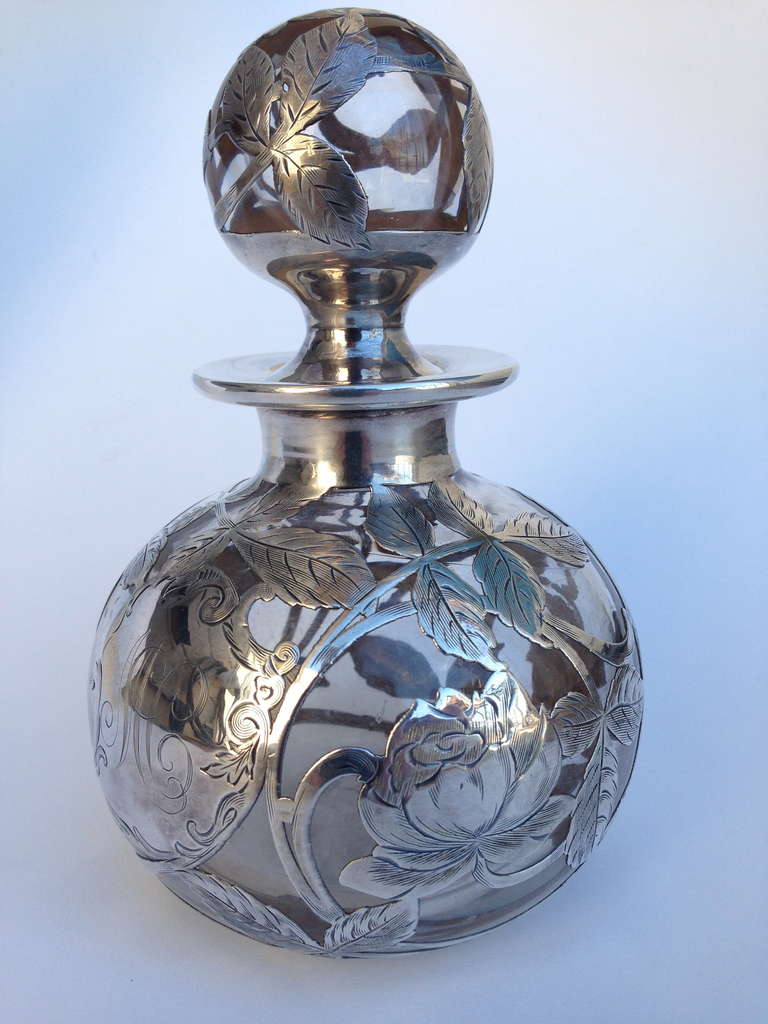 A very nice Art Nouveau sterling silver overlay perfume bottle. The condition is fantastic. The roses are unusual and rare, this is a nice large size perfume.