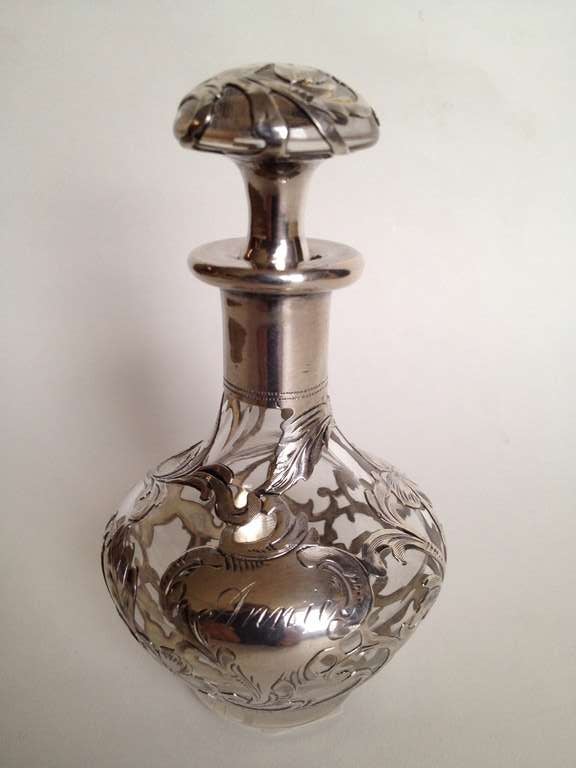 The shape is exceptional and the stopper extra deluxe on this wonderful example of silver overlay from the Art Nouveau period, even the bottom side of the stopper is overlaid in silver that is chased over as is the rest of this lovely
bottle. It's