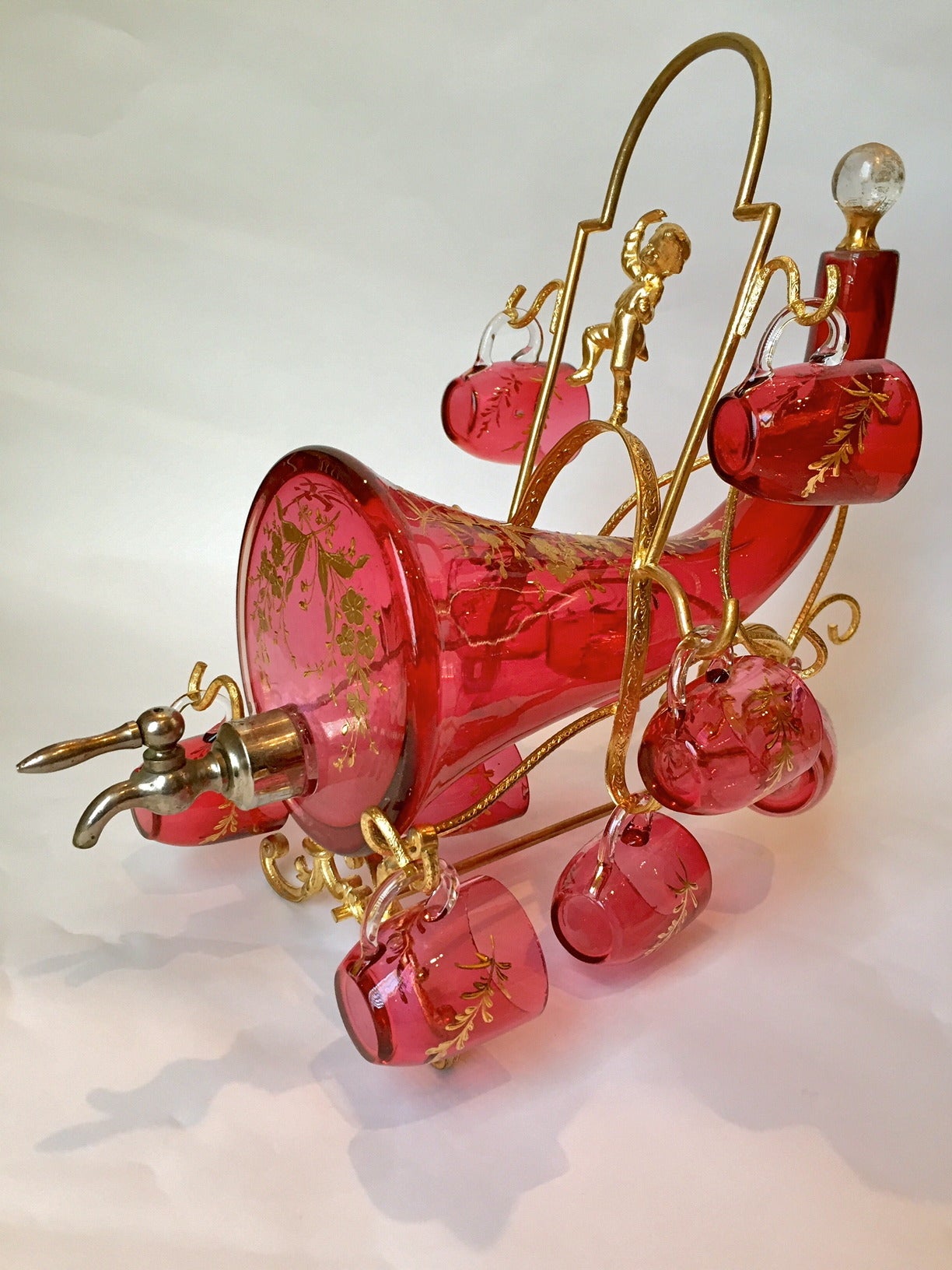 This is an exceptional example, very rare and so much to own and use. The unusual form and such a beautiful color of cranberry with gilt highlights.