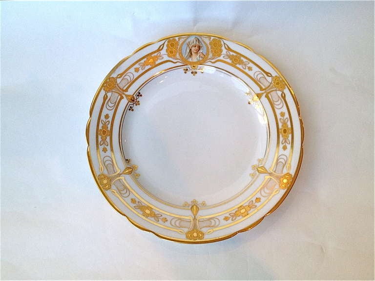 Rare and fantastic set of twelve service plates with beautiful portraits in miniature centering the gilt highlighted border, all hand done starting with the hand thrown plate, the portrait Handpainted and the gilding all expertly rendered.