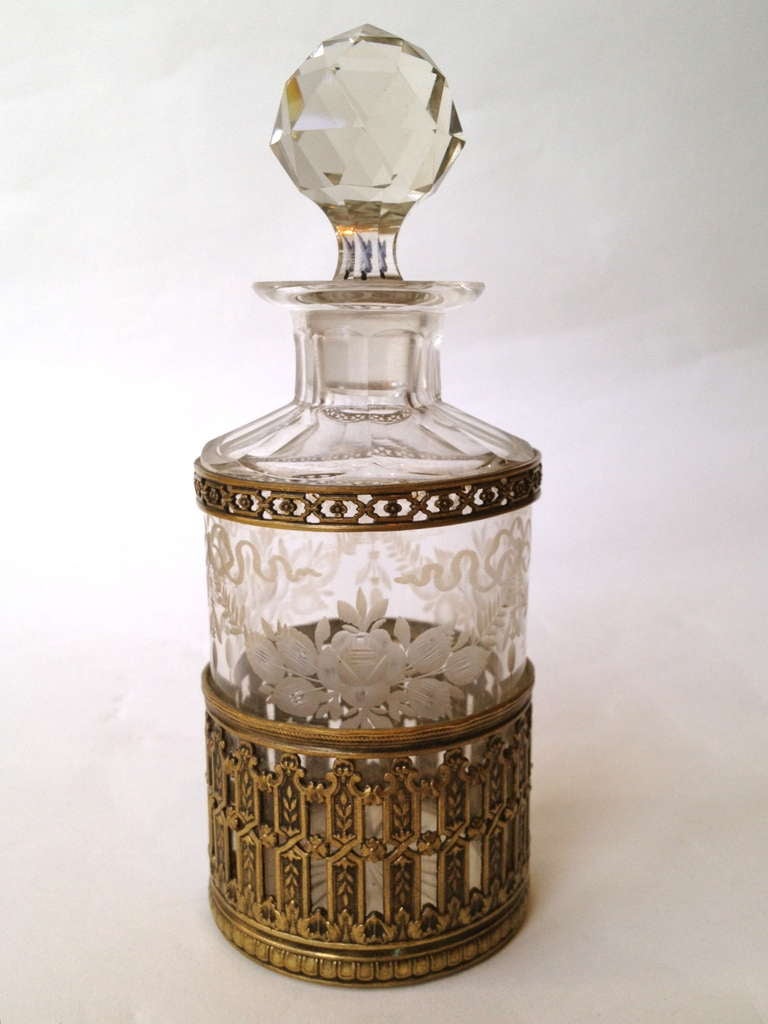A fine cologne,the Crystal bottle etched with flowers and ribbons, the gilt bronze finely cast and retaining its original gilt finish. In excellent condition.