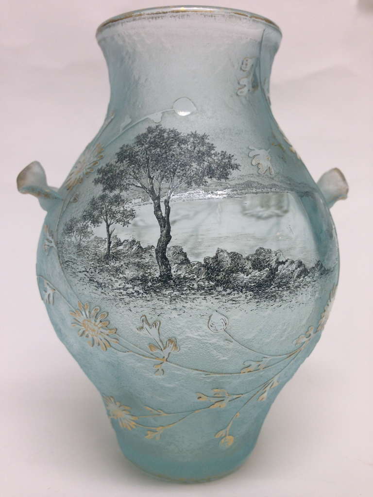 This wonderful example of Daum Nancy art glass with complexed work in cameo technique as well as both enameling and acid etching. Adding to the 
Rarity are the lovely applied handles flanking the blown out body. Then if that is not enough on the
