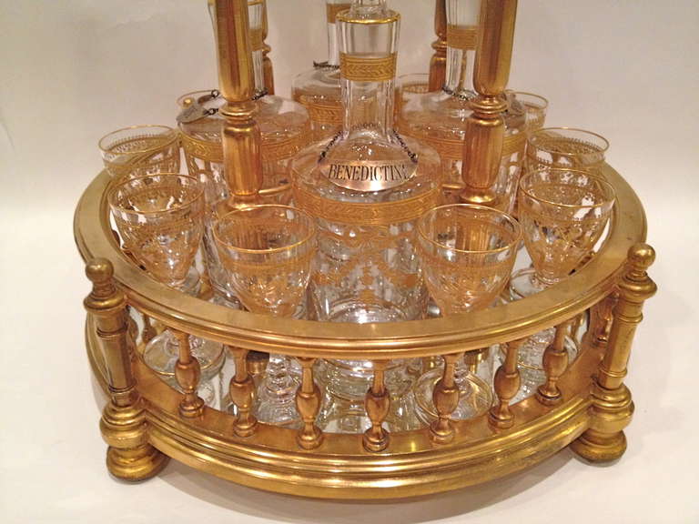 This Fine Temple Form Baccarat Tantalus is Rare and beautiful
Made in France c.1900 and is signed, cast into the bronze underneath the stand. The set is fitted with 10 glasses and 4 bottles with sterling tags. The dome top is cut with the the
