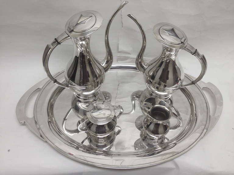 A fabulous mid century modern silver plated tea setwith matching tray In wonderful condition and So very stylish. The tray would be very useful by its self also.