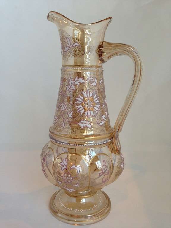 A very rare and fine Moser decanter jug with Opaline jewels. This
Example is showing off so many beautiful techniques. Starting with
the blown out panels, with gilt and enamel decoration. Also present is much ground coverage with scrolling gilt
