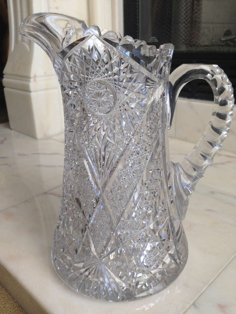 The beautiful geometric pattern on this pitcher is meant to catch 
And reflect the light and color in the room. It is so useful and can
Serve very well as a vase or a pitcher.