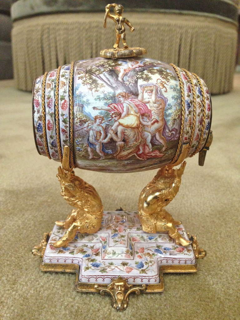 A very rare and exciting opportunity to acquire this fine perfume 
Of enamel on copper with beautifully cast,  chased and gilt bronze mounts, the barrel supported by two seated gnome type
Figures on a shaped and painted plateau base raised on feet