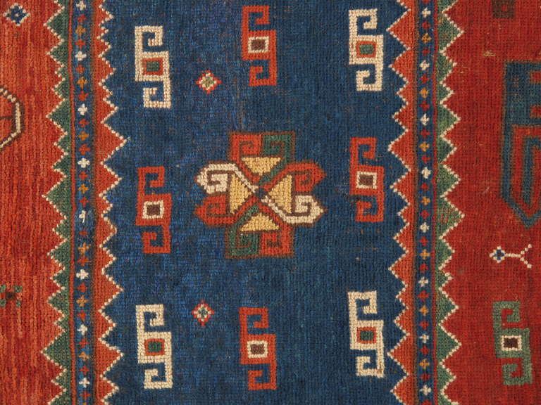 A quintessential Pinwheel Kazak rug! The design is distinguished by the typical 