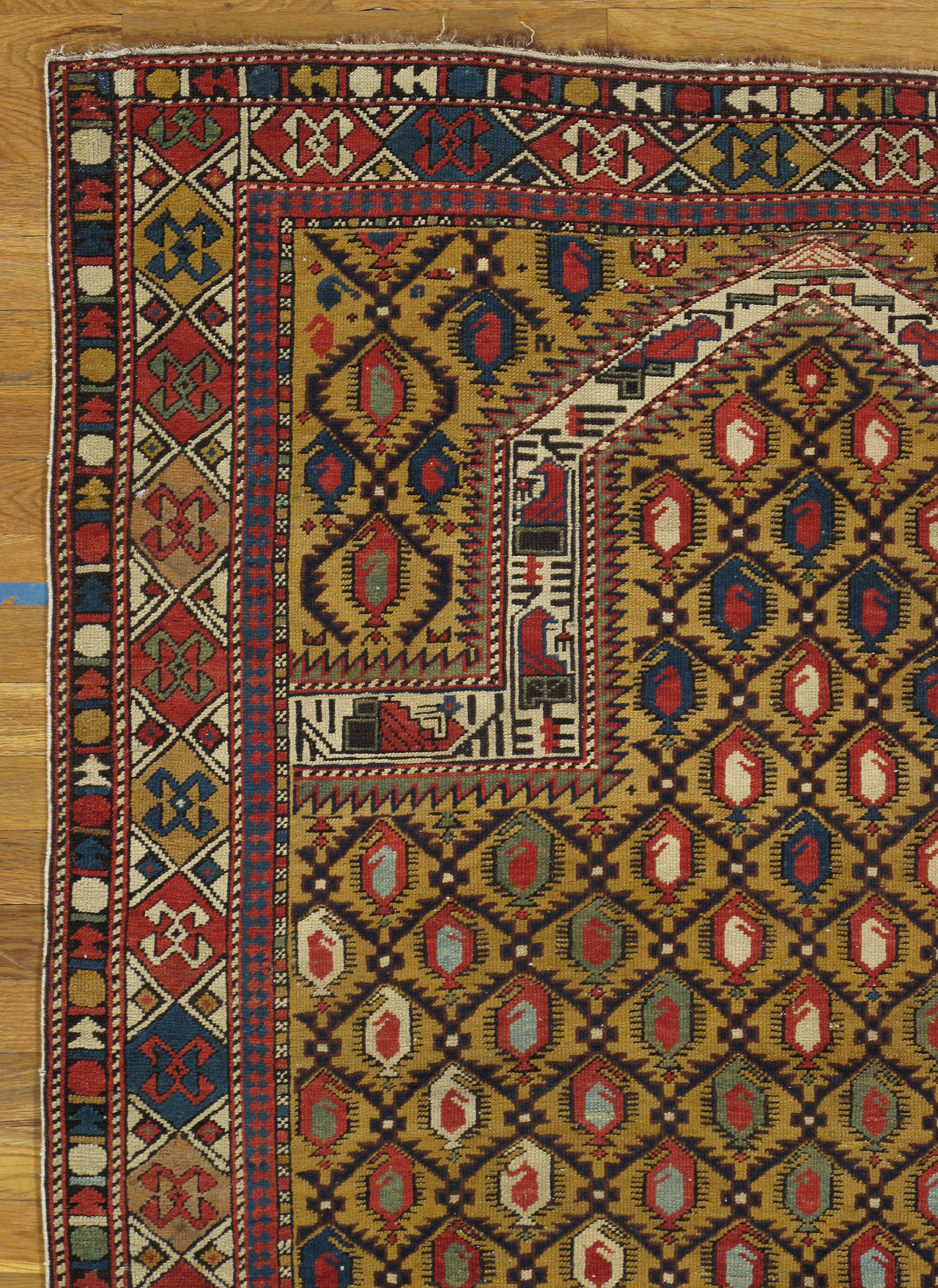 Unique Marasali prayer rug attributed to the Marasali group, this prayer rug from the Shirvan region has a brilliant golden-yellow field and a diamond lattice design in which angular botehs form color diagonals in relation to the central axis.