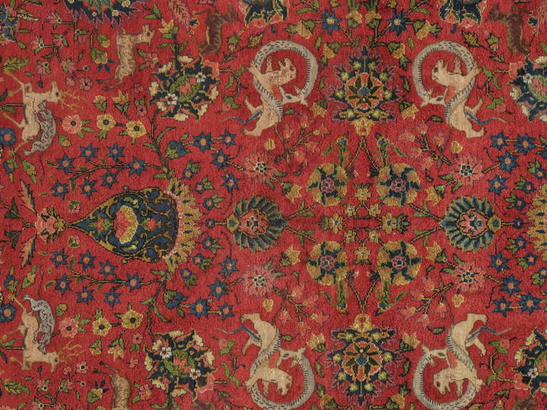 Finely woven Turkish silk rug, approximate: 300 knots per square inch. Turkish hunting design with animals of every kind showing here with a great vibrant red back ground. This rug possibly comes from the city Bursa where the best silks and Kaysaris