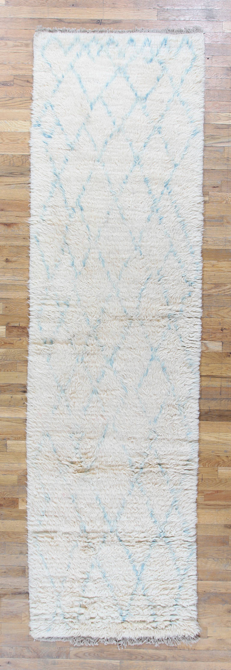 This Hand Woven Moroccan Runner has a deep wool pile using the highest quality of natural ivory wool and bold, geometric light blue pattern.

This classical pattern is modern an arranged to fill the elongated field beautifully. These expansive