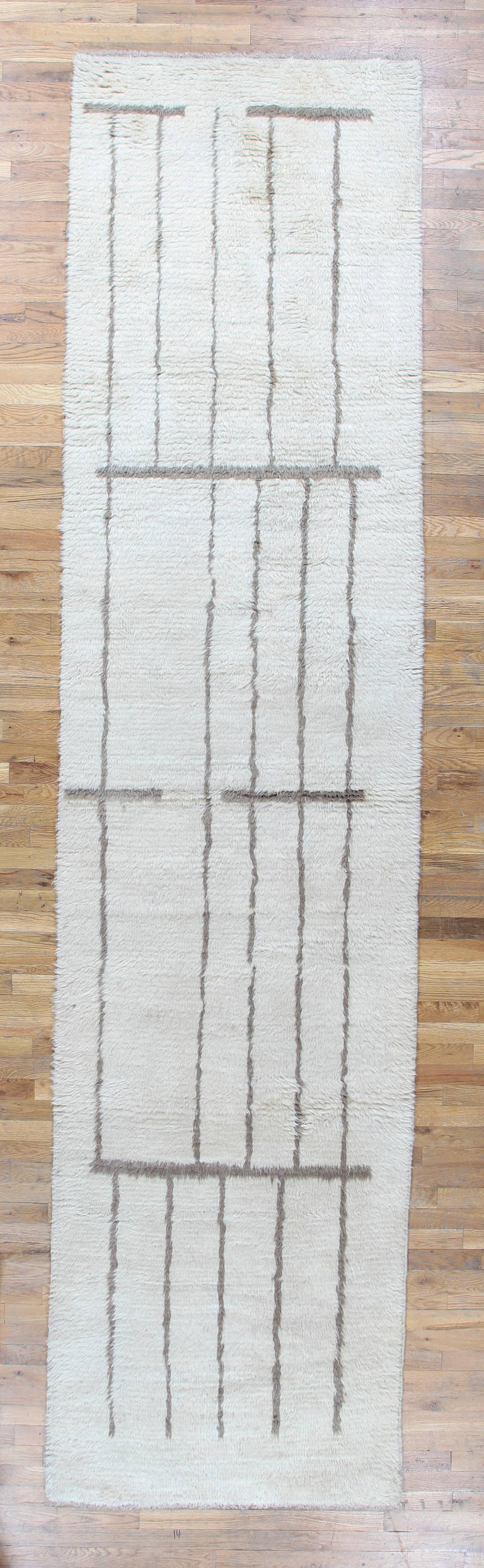 This Hand Woven Moroccan Runner has a deep wool pile using the highest quality of natural ivory wool and bold, geometric brown pattern.<br />
This classical pattern is modern an arranged to fill the elongated field beautifully. These expansive