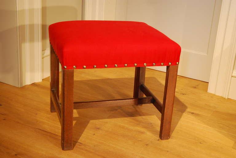 A Chippendale period mahogany stool with stuffover seat, the square legs united by H stretchers. Circa 1760.