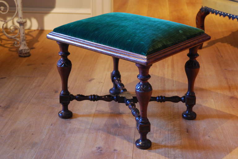 A rare carved mahogany Kentian stool, the leg showing strong affinities with the settee designed by William Kent for Devonshire House, carved by William Linnell, and the painted settees at Rousham House carved by John Linnell. The drop in seat