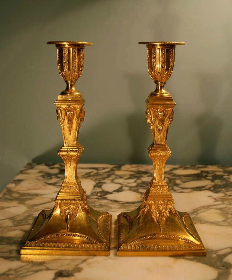 A fine pair of neo-classical ormulu candlesticks decorated overall with neo-classical motifs. Circa 1775