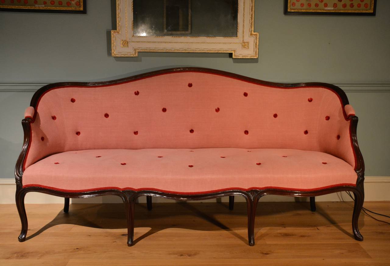 A moulded mahogany framed settee of sweeping outline standing on moulded cabriole legs in the French taste.
Circa 1770.