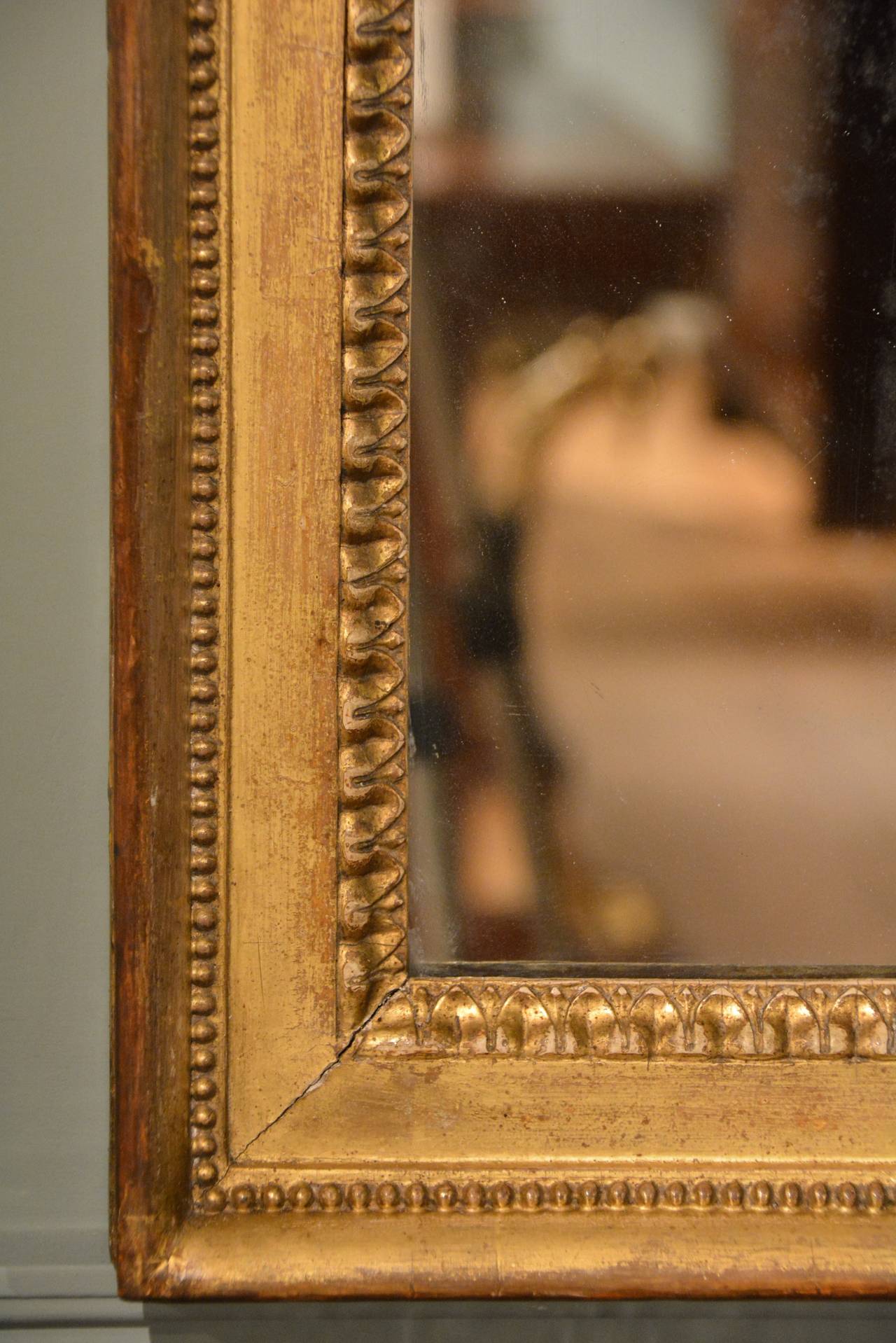 A large 18th Century English Neoclassical wall mirror of rectangular form retaining it's original gilding and mirror plate.

English Circa 1790