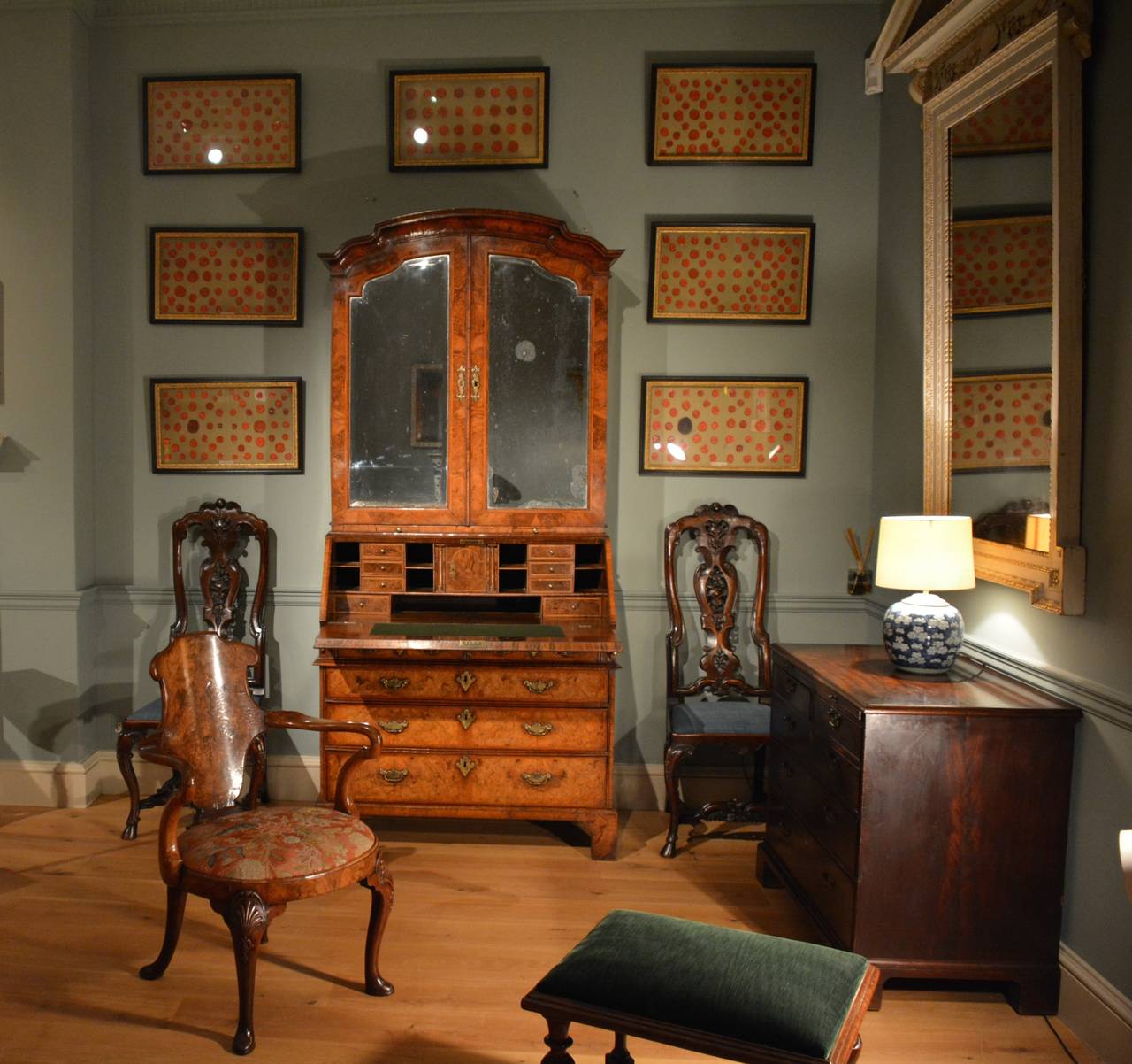 A fine quality early 18th Century bureau bookcase veneered throughout with burr walnut, having engraved brass mounts, the shaped cornice showing Chinese influence above a pair of shaped mirrored doors enclosing shelves to the upper section. The fall