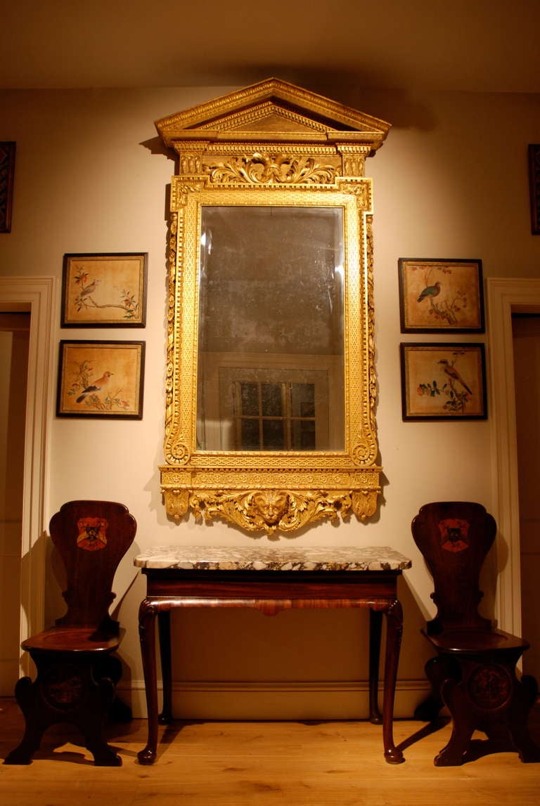 A George II side table, the brecia marble top standing on a mahogany base with cavetto frieze and cabriole legs with shells carved to the knees. Circa 1740.