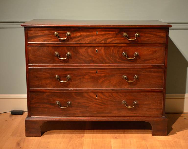 A fine quality mahogany chest of drawers in the Chippendale taste, having a finely figured top and drawer front retaining it's original brasses and bracket feet with a panelled back. circa 1760.