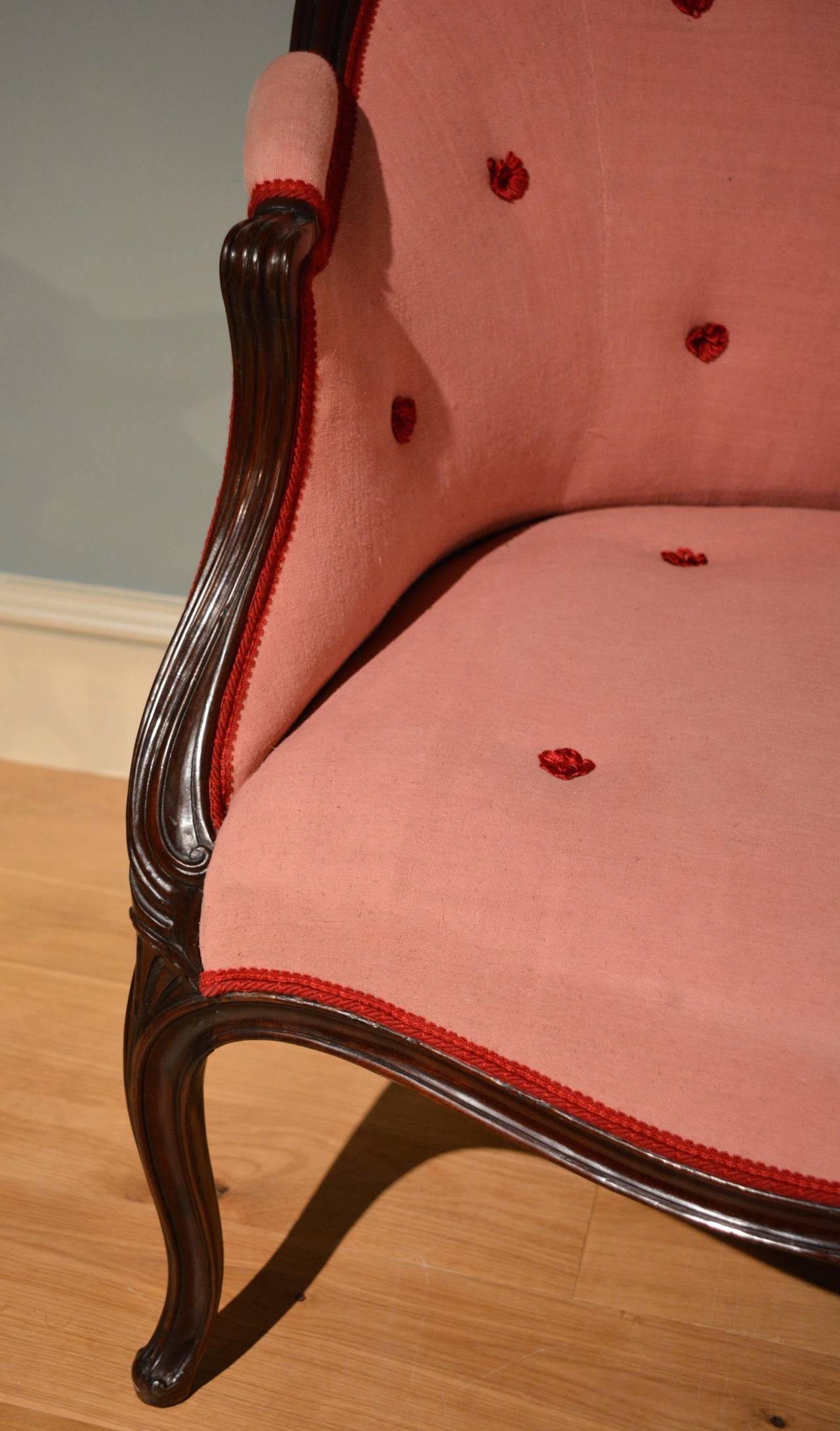 A moulded mahogany framed settee of sweeping outline standing on moulded cabriole legs in the French taste,
circa 1770.