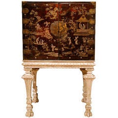 A Late 17th Century Chinese Lacquer Cabinet on its 18th Century Silvered Stand