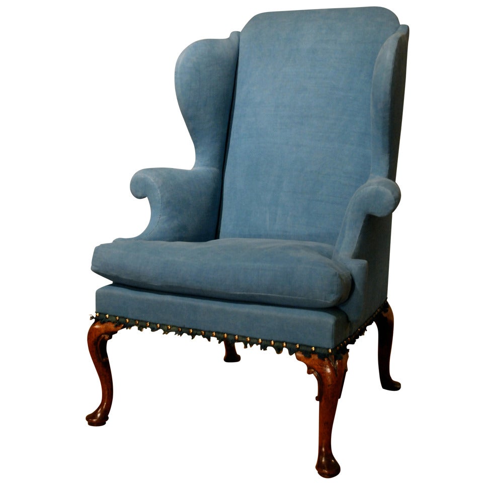 A cabriole leg walnut wing chair. Circa 1720.