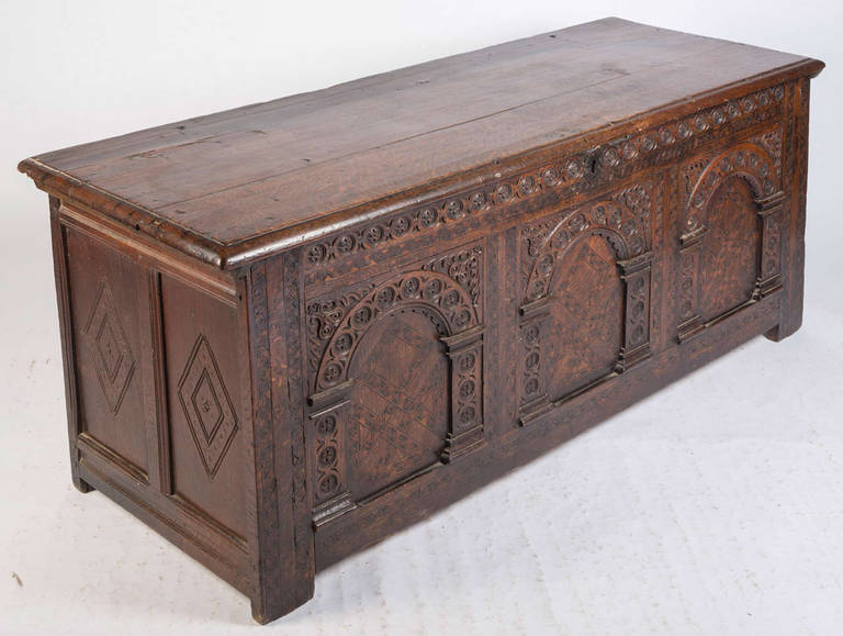Very good arcaded oak coffer with marquetry inlay in the panels and of excellent color and patination.