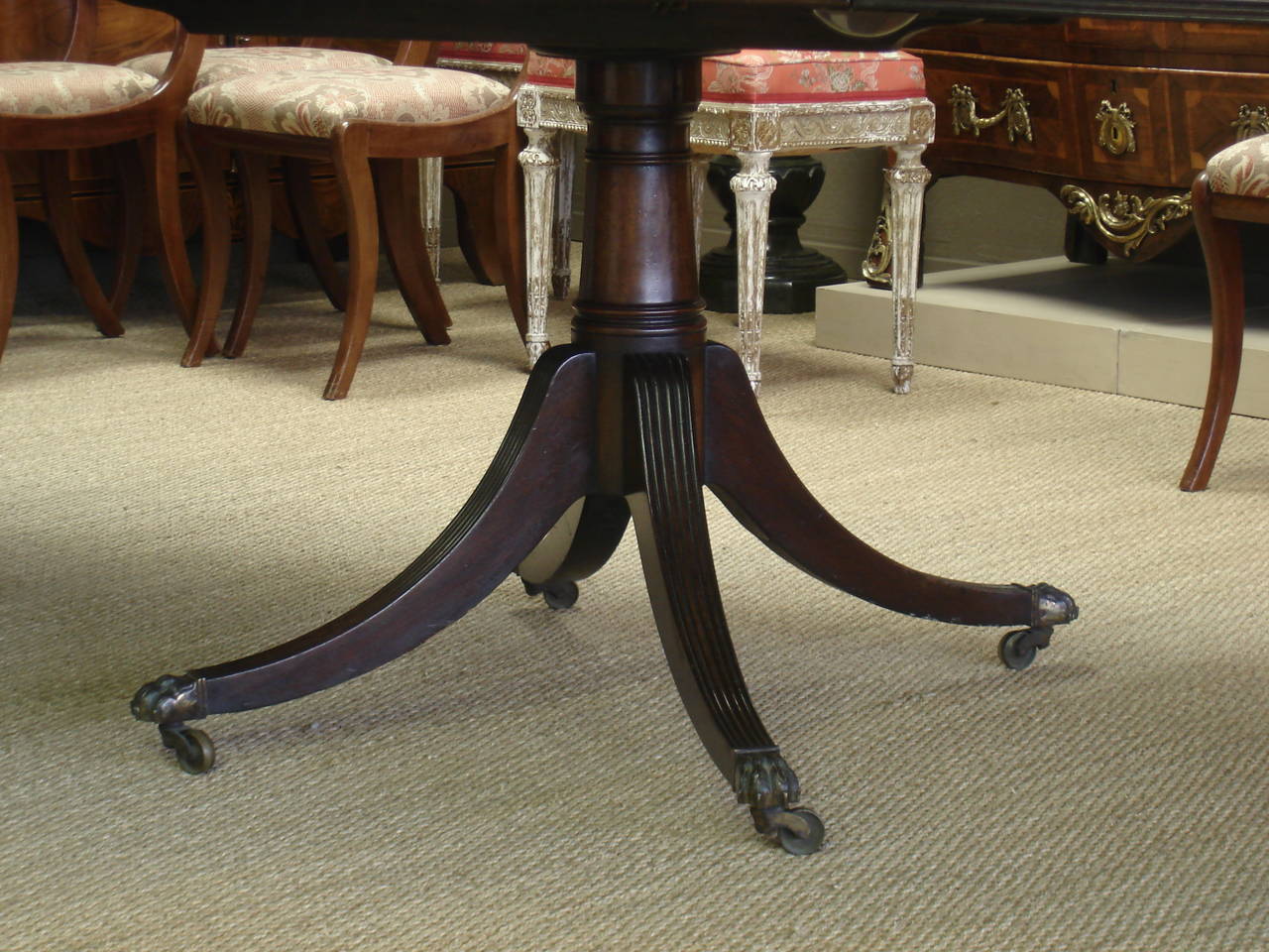 Carved Late George III or Regency Period Mahogany Triple Pedestal Dining Table