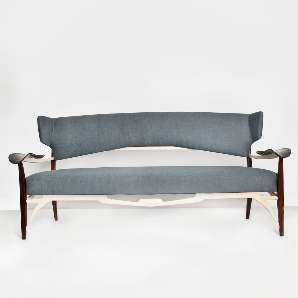 Rare and important sofa by Carlo Enrico Rava, in dark-stained walnut with carved lacquered stretchers, Italy, circa 1947.

Provenance and documentation available

