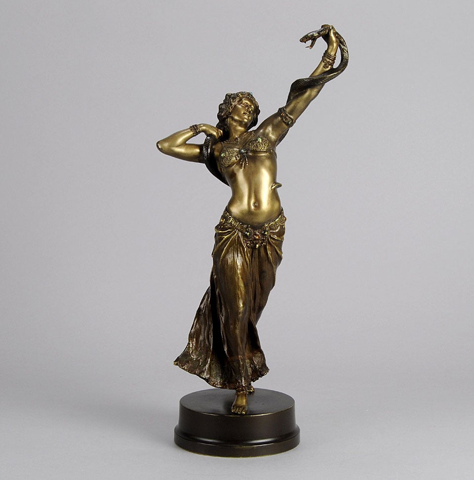 An impressive early 20th Century Austrian cold painted bronze study of a young Oriental beauty dancing with a snake coiled around her arms, with excellent detail and fine colour, signed with the Bergman 'B' in an amphora vase.

Date :
   