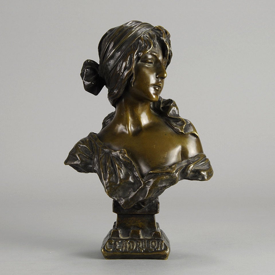 An attractive late 19th Century French bronze bust, with deep multi-hued patination and excellent detail. The beautiful character with head dress and loosely draped blouse representing ’Cinderella’ from the famous French opera. The bronze is signed