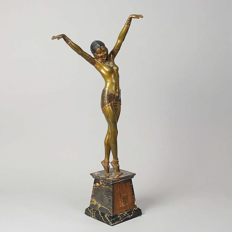 A superb early 20th century cold painted gilt and enameled bronze figure of an attractive female dancer in a stretched pose wearing a scant Egyptian costume, with exceptional detail. A subject from the Dance Halls of Paris highly characteristic of