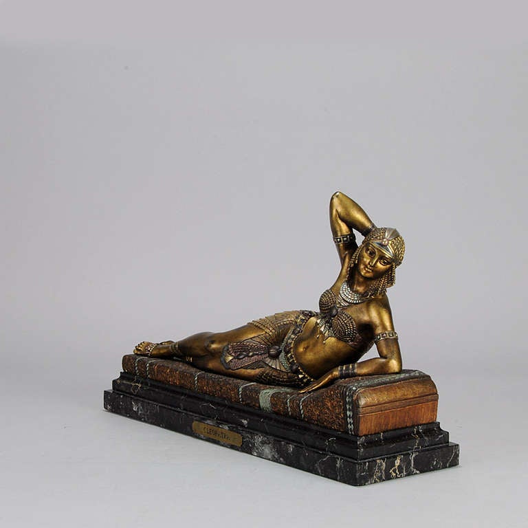 A stunning and very striking early 20th Century cold painted bronze figure of the beautiful reclining 'Cleopatra', with excellent hand finished detail and rich enamel and gilt colour, signed Chiparus to bronze and with Etling Paris foundry mark.