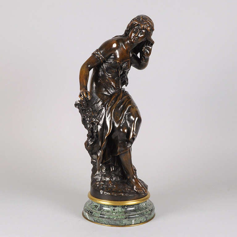 A very pretty early 20th Century Art Nouveau bronze figure of a young beauty in a seated pose with her hand to her ear listening out for an echo with fabulous detail and colour, raised on a turning marble base, signed Math Moreau, inscribed Hors