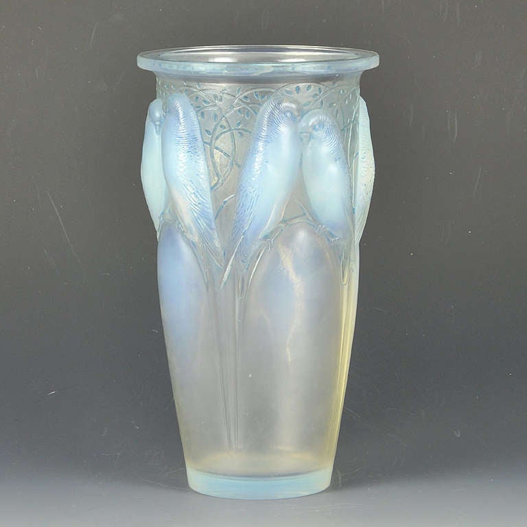 A beautiful early 20th Century French frosted glass vase, with decorative raised figures of birds amongst branches heightened with a wonderful blue opalescent colour. The attractive design, detail and colour make this vase a popular choice; signed