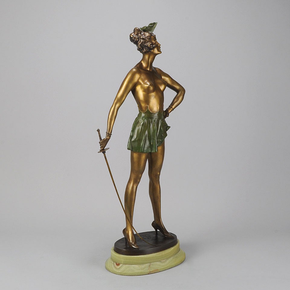 A captivating erotic early 20th century gilt and enamel cold painted bronze figure of a semi clad lady with fencing sword, raised on a shaped Brazillian green onyx base, signed Bruno Zach and stamped Austria. This is a wonderful large example of the