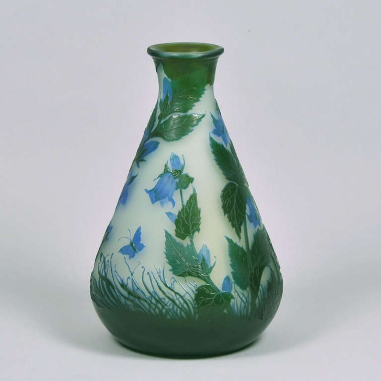 A stunning late 19th Century French cameo glass vase decorated with both blue and green floral design, enhanced with butterflies acid cut against a mint background, a fabulous vase with wonderful detail and vibrant colour, signed Gallé