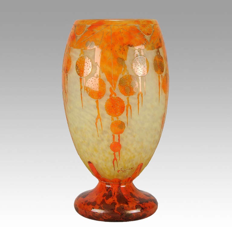 A dramatic cameo glass vase of large proportion, the deep orange layer cut through with cascading orange tree design against a rich yellow background. Signed Le Verre Francais on top of foot rim and further signed Charder in cameo

Date :
   