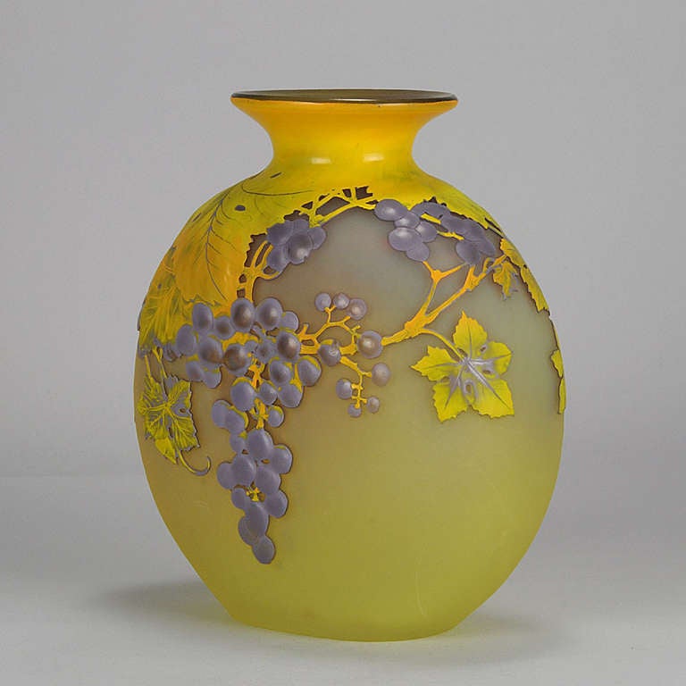 A stunning early 20th Century French souffle vase of moon form, the beautiful pale blue and purple flowering berry landscape design acid cut against a vibrant yellow field. This vase exhibits superb colour and finish, signed Galle.

Date :
   