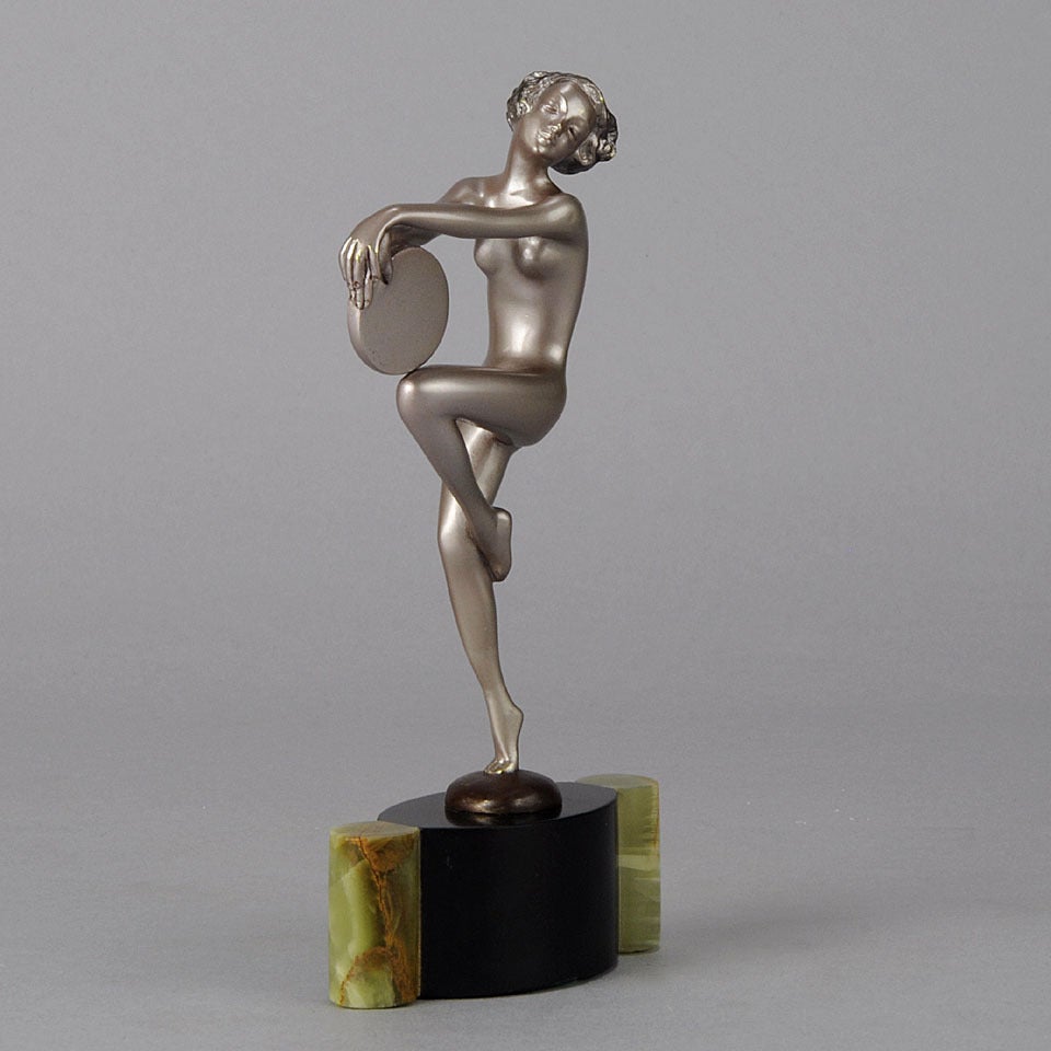 A highly stylised and energetic early 20th Century Austrian bronze figure of an Art Deco beauty dancing with tamboruine, this charming bronze exhibits good cold painted colour and detail, signed Lorenzl to base and raised on a black and green onyx