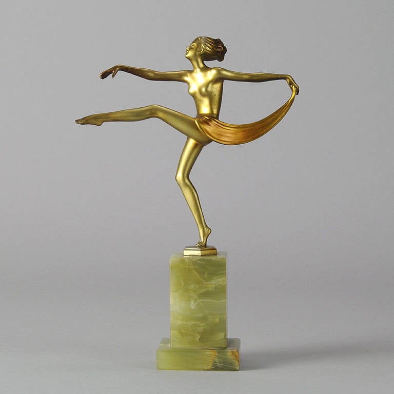 A delightful small version of one of the most desirable and beautiful examples of Lorenzl's work. The fine bronze figure of a semi naked dancer in stylized pose has a wonderful cold painted golden surface with fine hand chased detail; raised on a