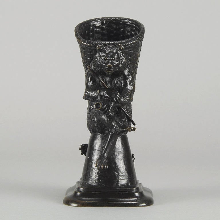 An amusing late 19th Century bronze group of a bear seated upon a stump with a basket on his back holding a long pipe, whilst his errant friend, the dog, ppers round the corner. The bronze with very fine rich brown colour and intricate detail,