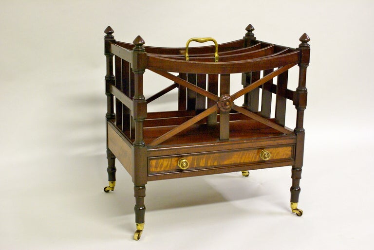 On turned legs with original castors and with the drawer front, sides and back in contrasting pale figured mahogany veneer. The upper section with unusual X strecher and pateria and original brass carrying handle. Circa 1835