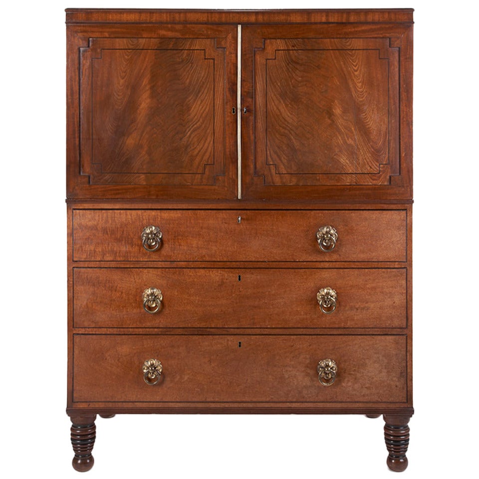 A Regency period ebony inlaid mahogany low linen press/ cupboard For Sale