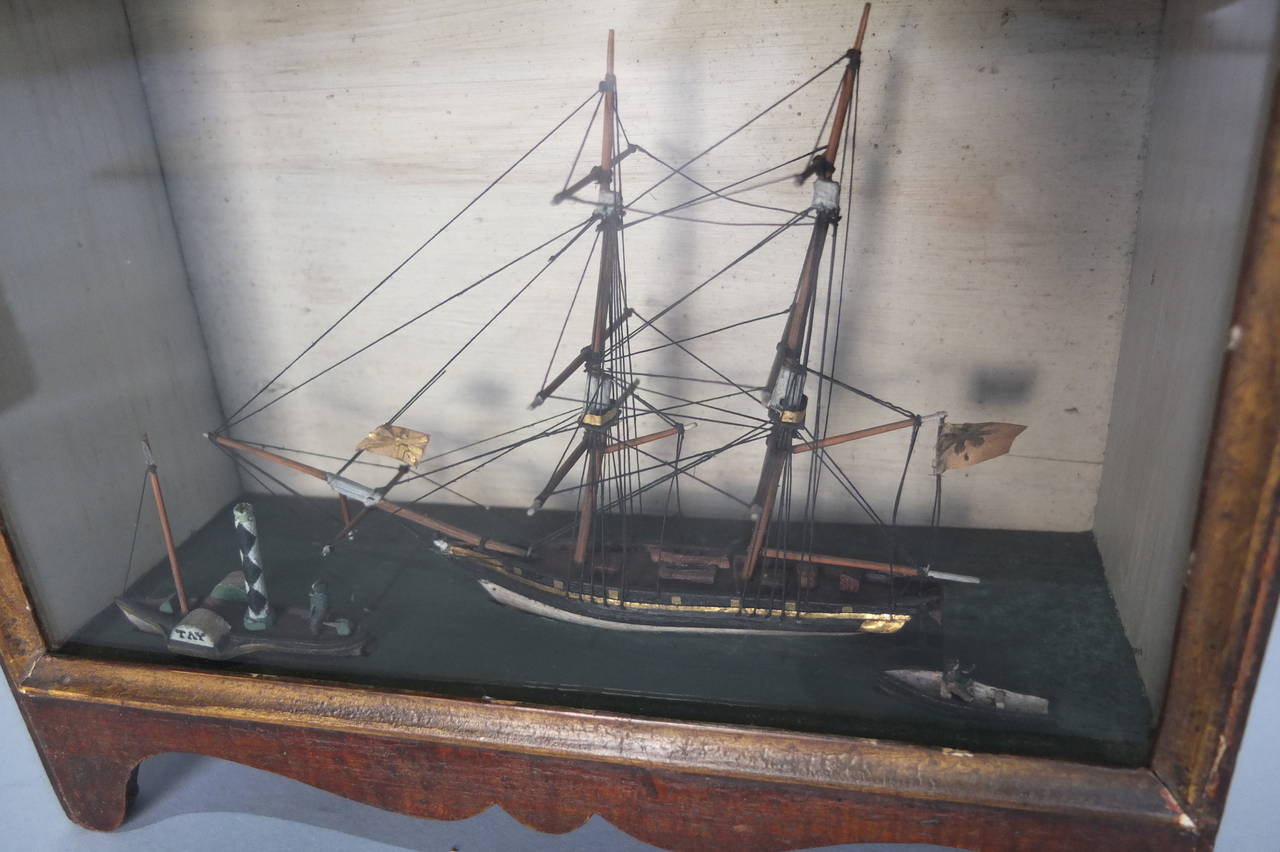 This is a rare survival. The painted case has the original decoration and encloses a wonderful shipping scene of a tug pulling a clipper and a small rowing boat in the foreground.
The flags and are in gold foil and have remained beautifully bright.