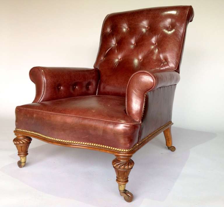 A good and very comfortable leather arm chair. This chair is covered in fine old hide and was re-upholstered to a high standard some years ago and the leather is now a nice aged colour. Retains original gilded castors.